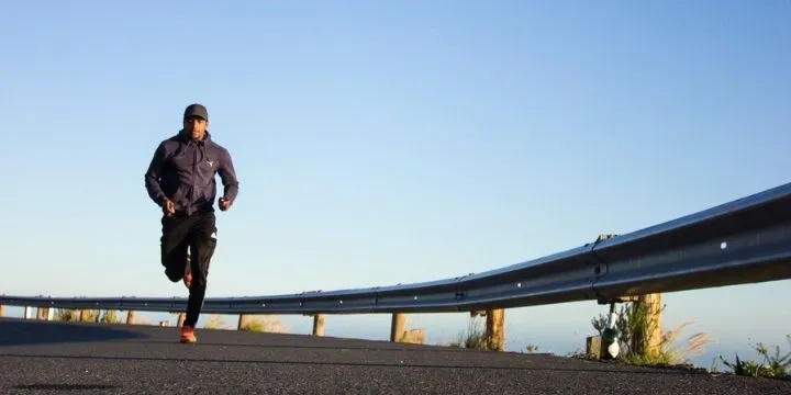 A man running on a roadside.