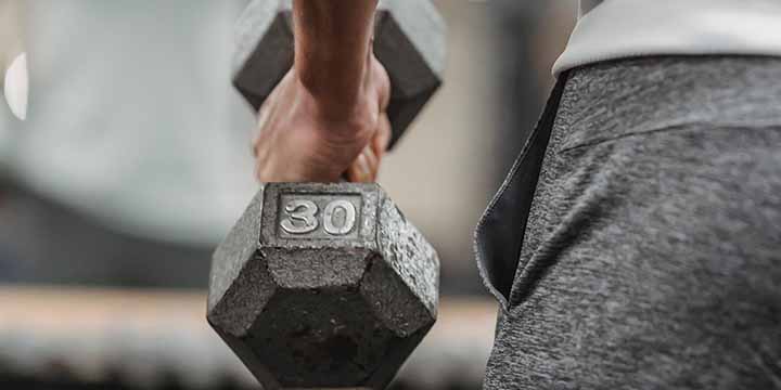 A man holding a dumbbell.