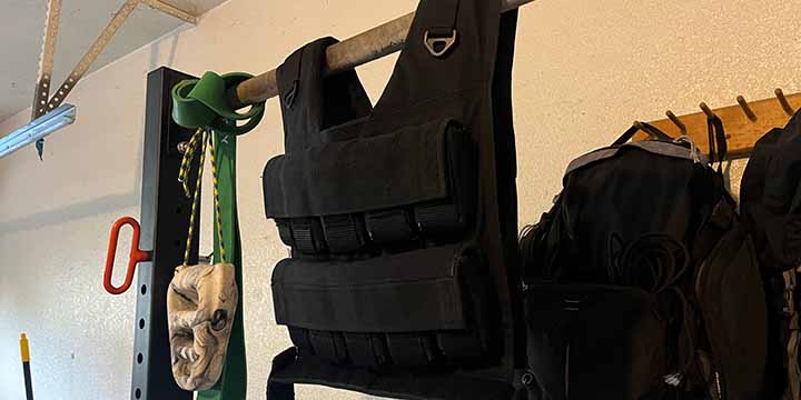 My personal V-Max weighted vest on the squat rack in my garage.