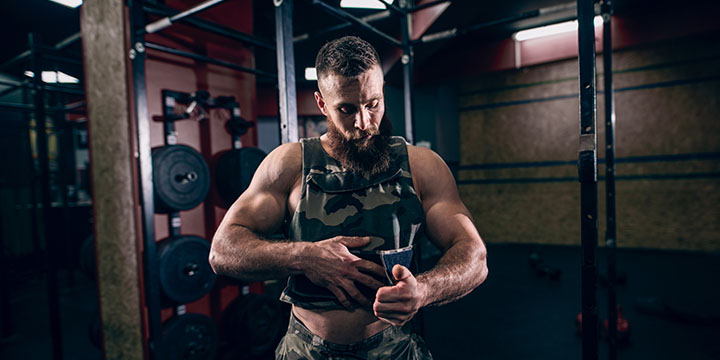 A lifter in a weighted vest getting ready for the Murph Challenge.